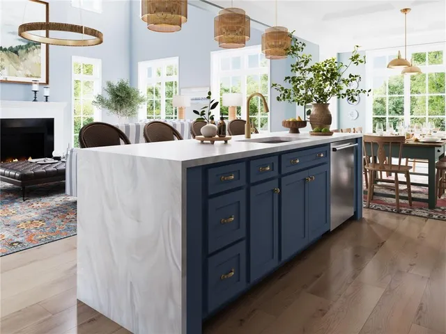 a kitchen with a sink a potted plant and a wooden floor