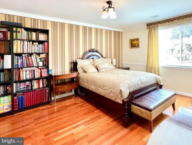 a bedroom with a bed and a book shelf