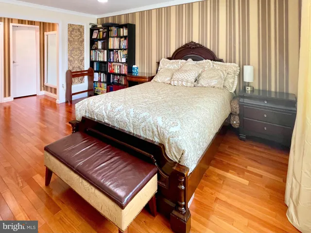 a bedroom with a bed window and a table in it