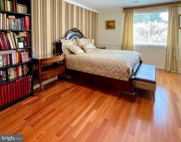 a bedroom with a bed furniture and a book shelf