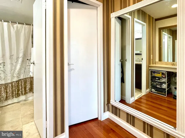 a view of a hallway with wooden floor and staircase