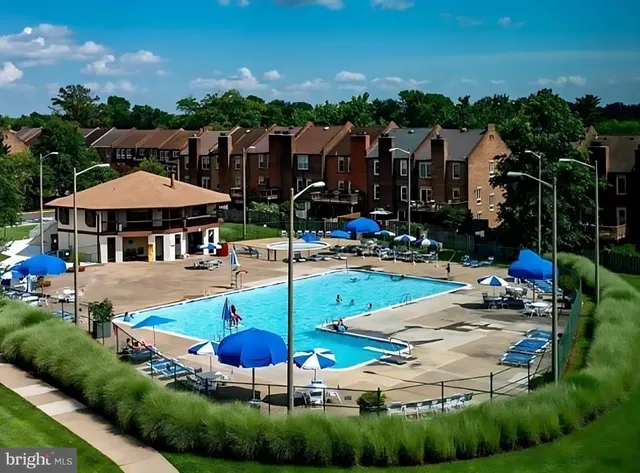 a view of a house with swimming pool and sitting area