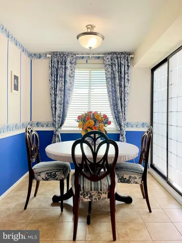 a view of a dining room with furniture and window