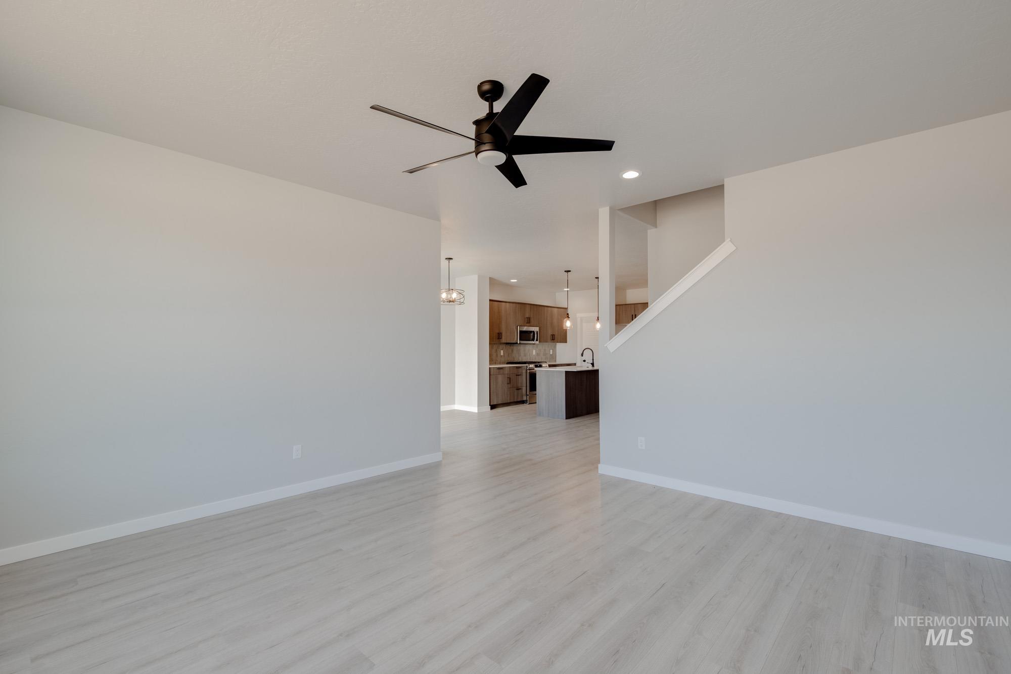 2168 South Border Way Meridian, ID 83642 - Photo 12 of 25 Unfurnished living room with ceiling fan, light wood-style flooring, and recessed lighting
