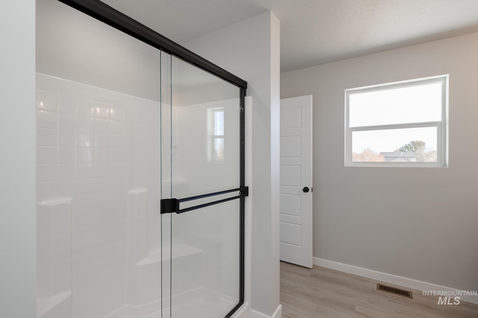 2168 South Border Way Meridian, ID 83642 - Photo 18 of 25 Full bath with a stall shower and light wood-style floors
