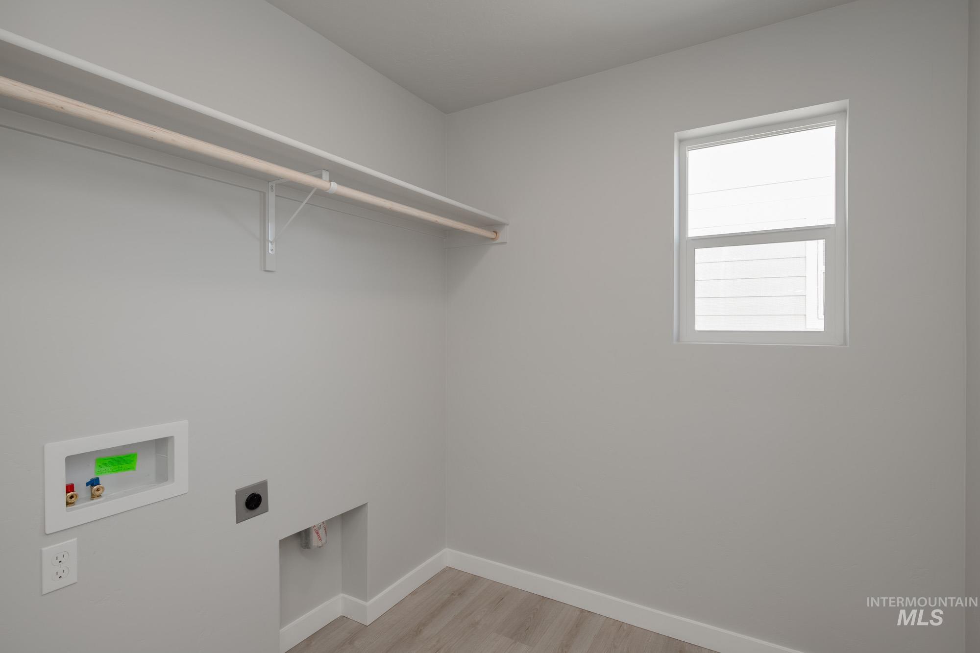 2168 South Border Way Meridian, ID 83642 - Photo 20 of 25 Laundry room with light wood-style flooring, hookup for an electric dryer, and washer hookup