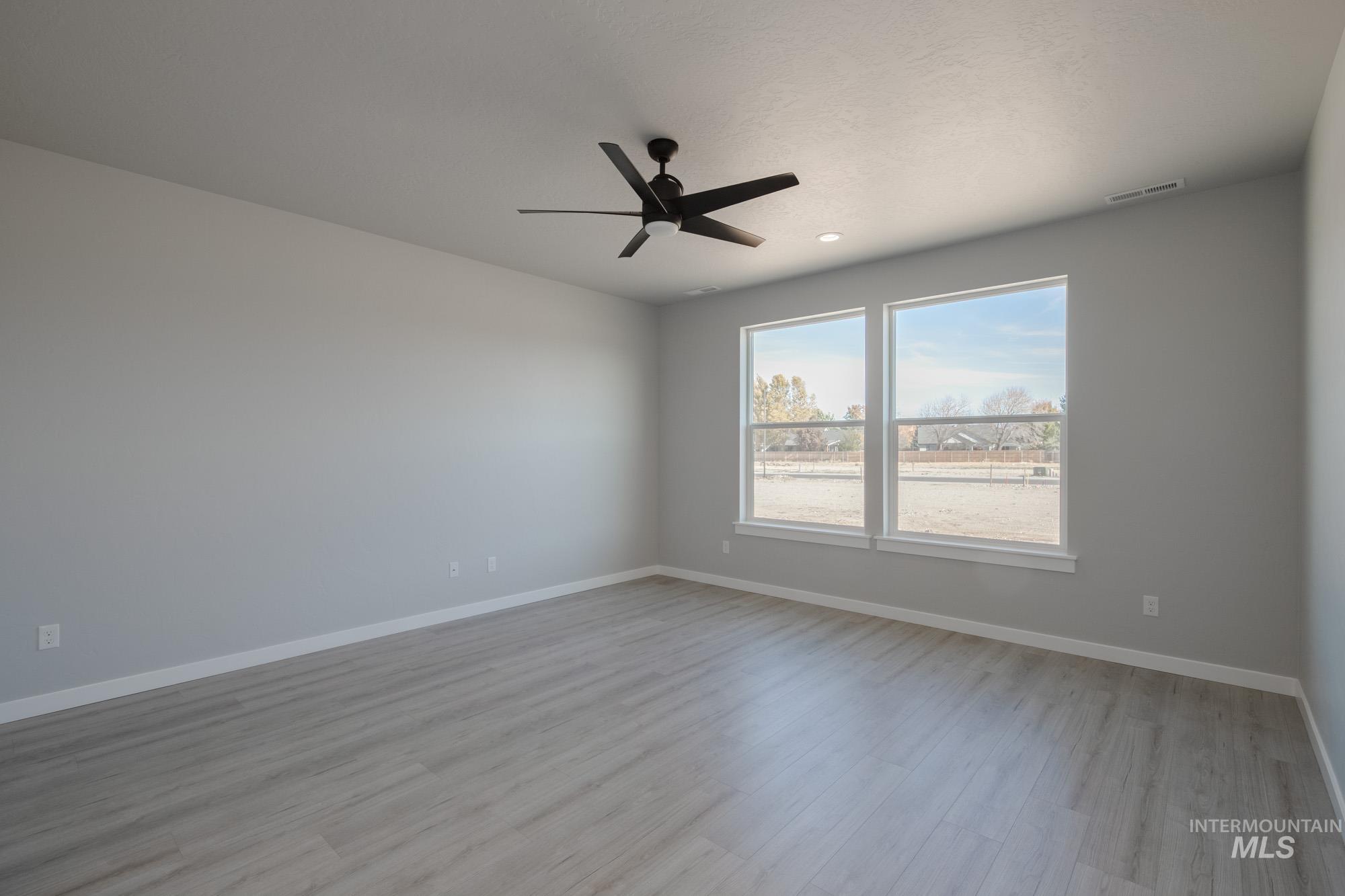 2168 South Border Way Meridian, ID 83642 - Photo 10 of 25 Spare room featuring ceiling fan and light wood-type flooring