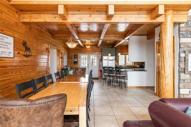 a outdoor space with lots of tables a chairs and chandelier