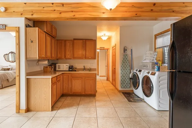 a view of a kitchen with refrigerator and washer