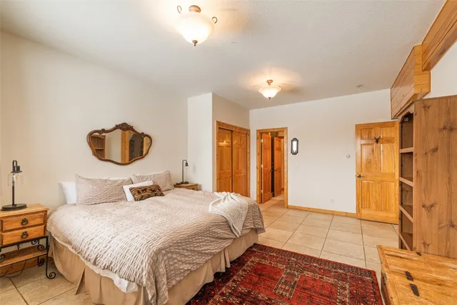 a bedroom with a large bed and a chandelier