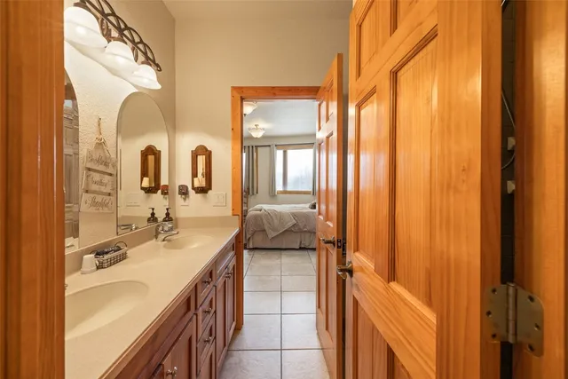 a spacious bathroom with a double vanity sink and a mirror
