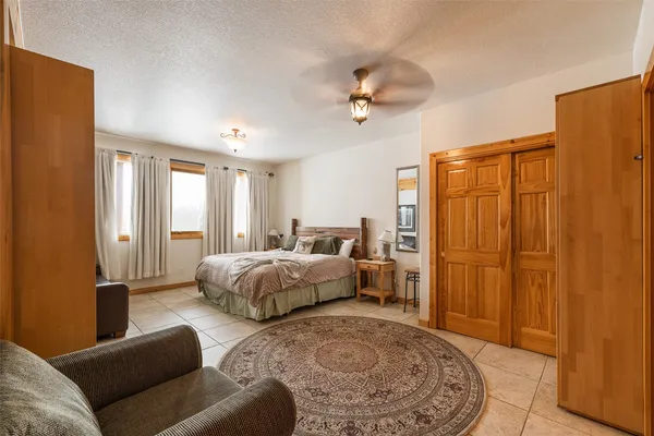 a bedroom with a bed and glass windows
