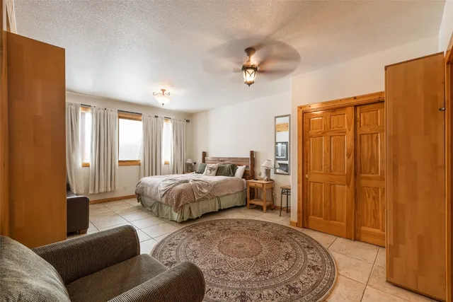 a spacious bedroom with a bed a couch and a dresser