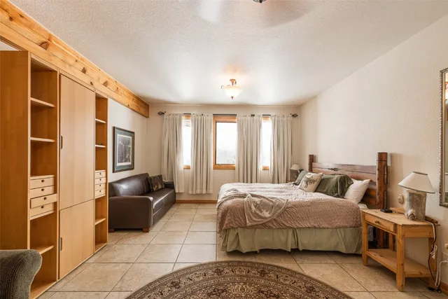 a bedroom with a bed and glass door