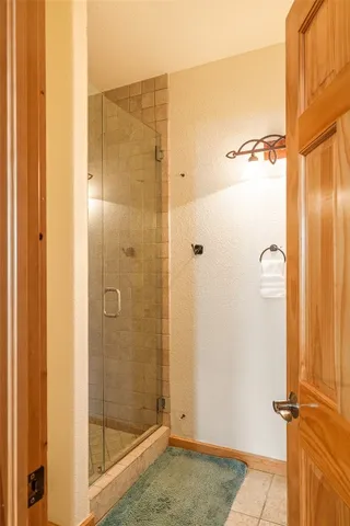 a bathroom with a shower and a glass door