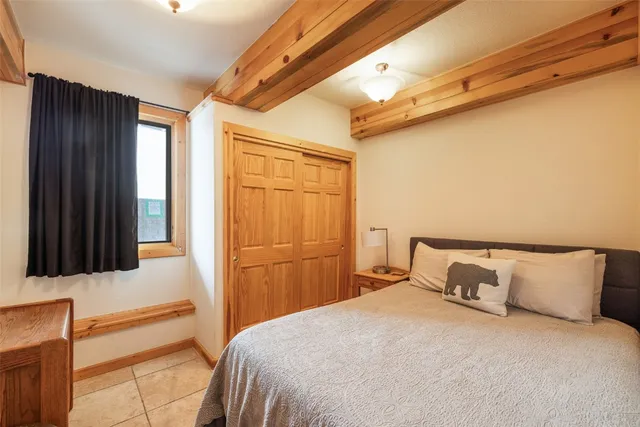 a bedroom with a bed and a closet