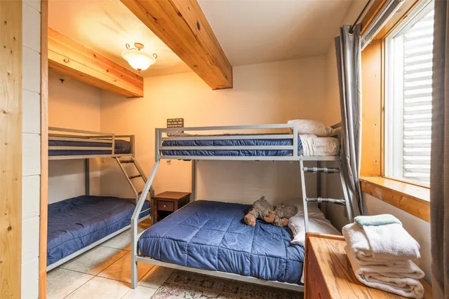 a living room with furniture a fireplace and next to a window