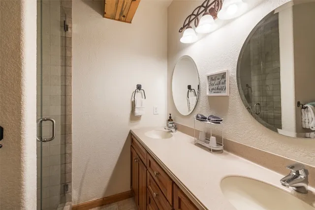 a bathroom with a sink double vanity and a mirror
