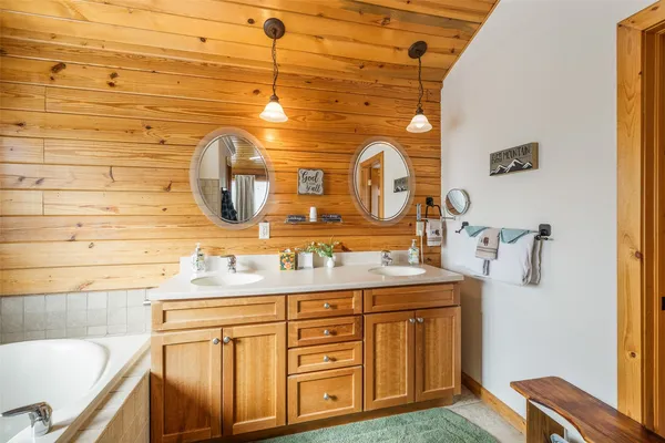 a bathroom with a granite countertop sink and a large mirror