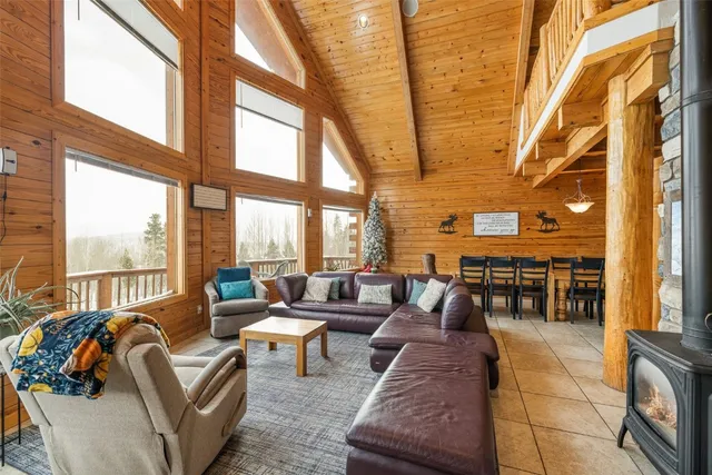 a living room with furniture and floor to ceiling windows