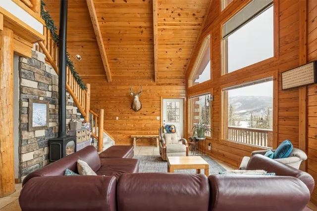 a living room with furniture a large window with outer view