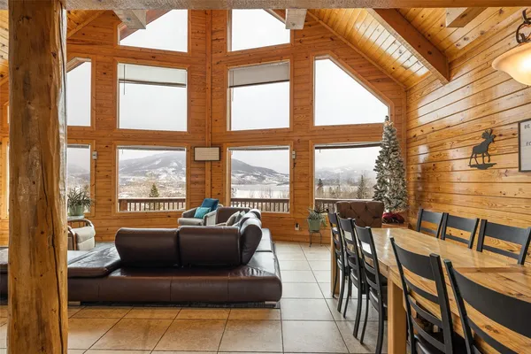 a living room with furniture and floor to ceiling windows
