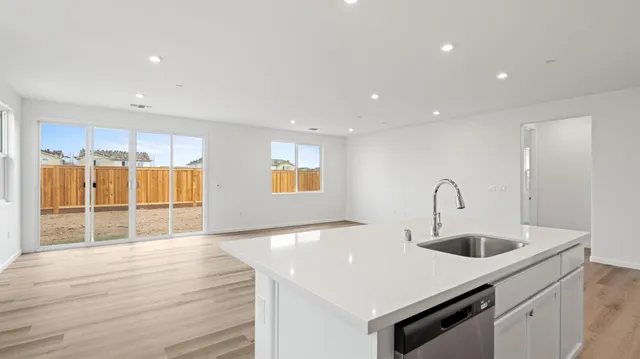 a kitchen with stainless steel appliances a sink and a refrigerator