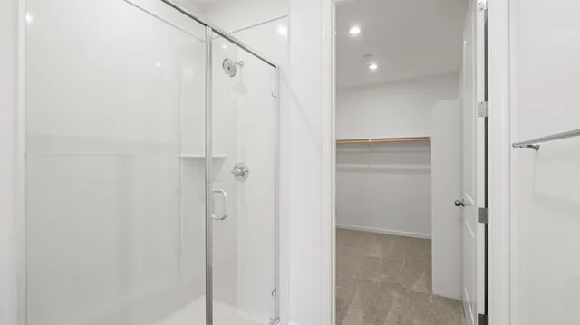 a bathroom with a shower and a glass door