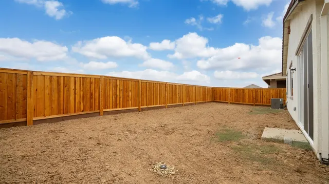 a view of a house with wooden fence