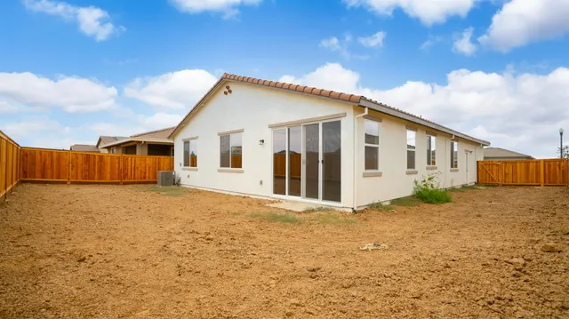 a view of an house with backyard space and balcony