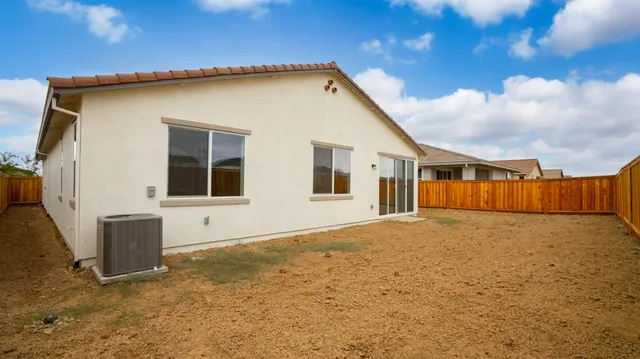 a view of an empty room with wooden fence