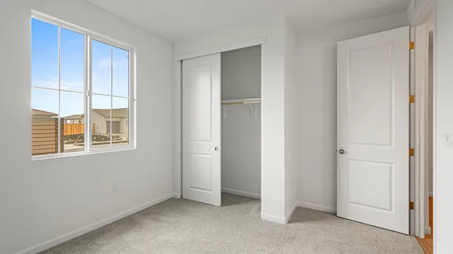 a view of an empty room with a closet