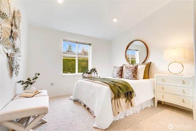 a bed room with a bed and a chair