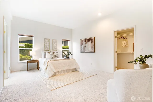 a spacious bedroom with a bed and a couch