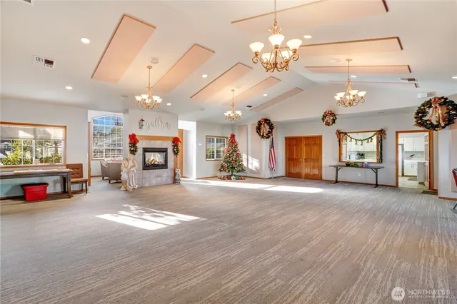 a view of a hall with a flat screen tv and a fireplace