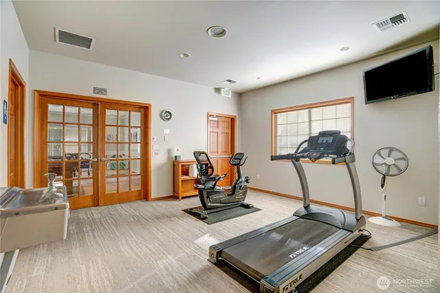 a room with gym equipment and a large window