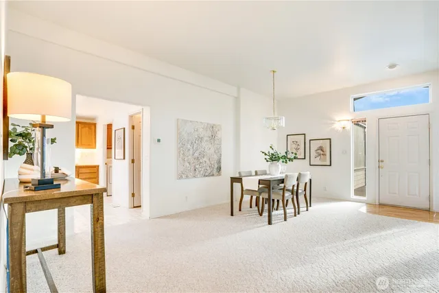a dining room with furniture and a view of kitchen
