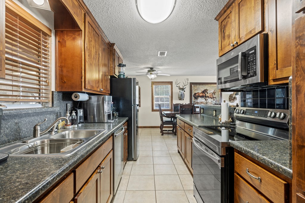 3417 Kc 443 Harper, TX 78631 - Photo 39 of 65 a kitchen with stainless steel appliances granite countertop a sink stove and cabinets