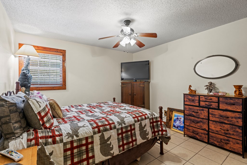 3417 Kc 443 Harper, TX 78631 - Photo 45 of 65 a bedroom with a bed and a chandelier