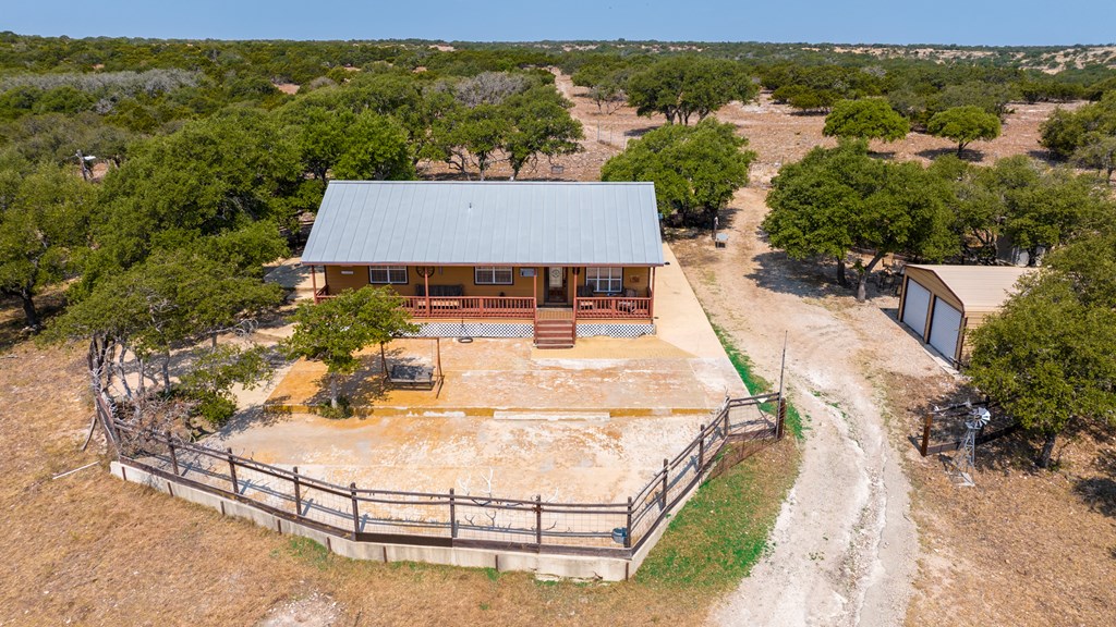 3417 Kc 443 Harper, TX 78631 - Photo 5 of 65 an aerial view of a house with swimming pool and large trees