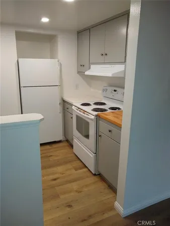 a kitchen with a sink a stove and a refrigerator