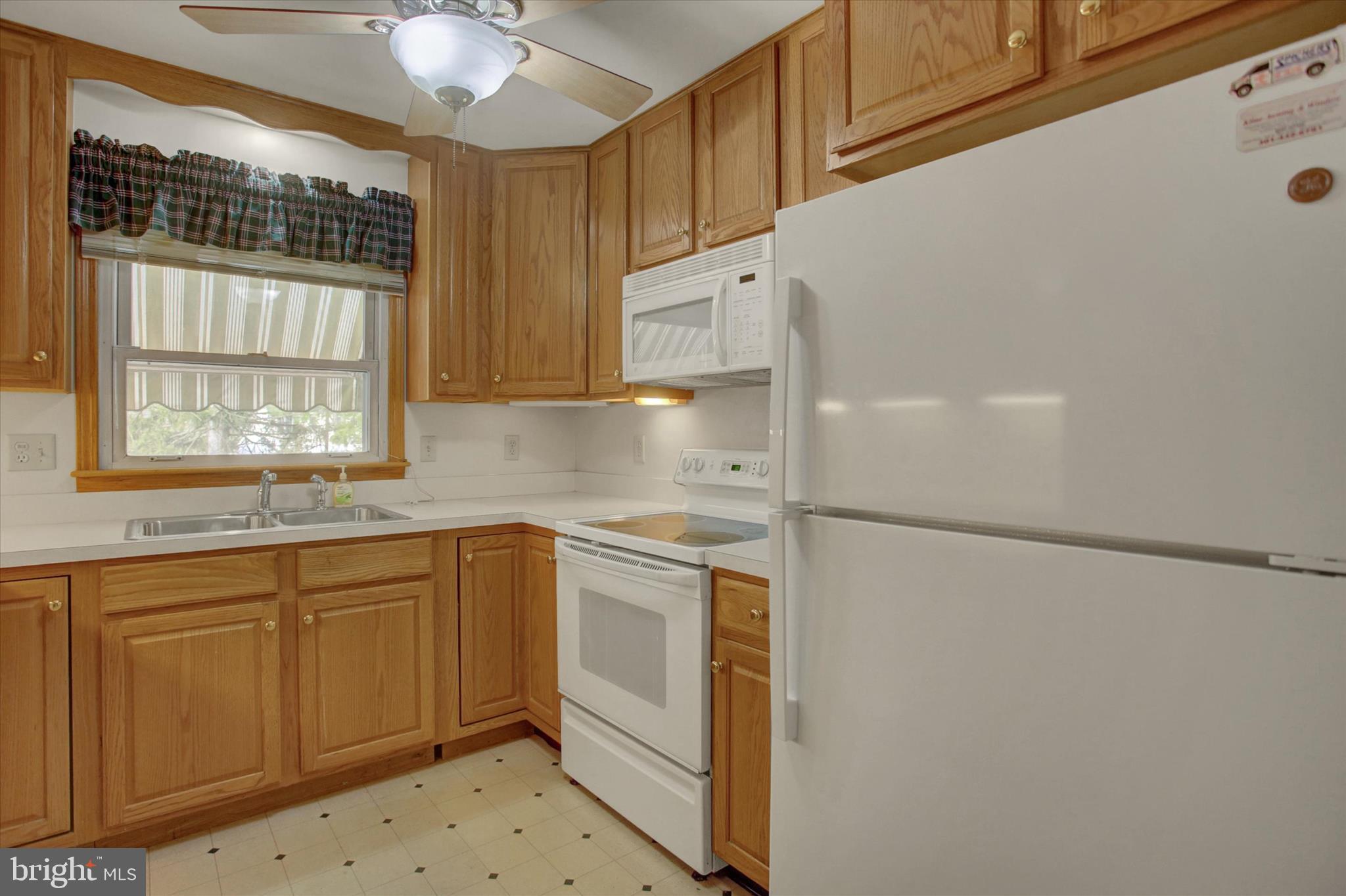 18514 Indian Cottage Road Hagerstown, MD 21742 - Photo 27 of 56 a kitchen with white cabinets and white appliances