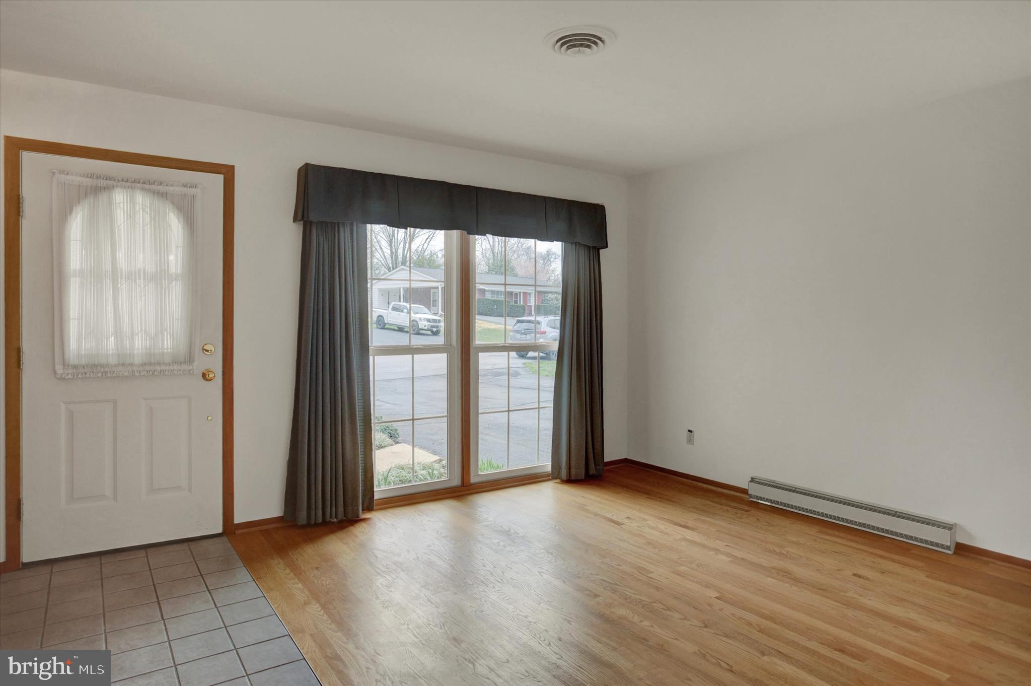 18514 Indian Cottage Road Hagerstown, MD 21742 - Photo 7 of 56 an empty room with wooden floor and windows