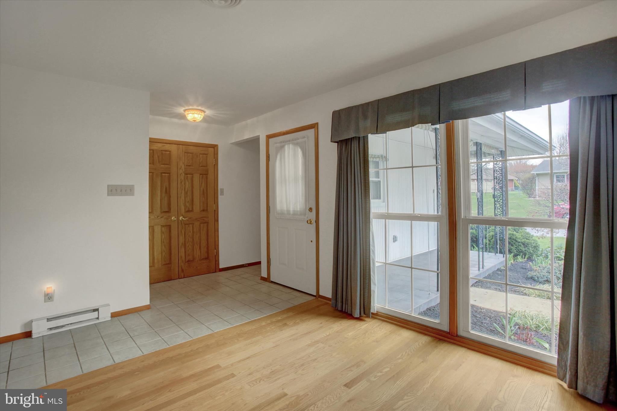 18514 Indian Cottage Road Hagerstown, MD 21742 - Photo 8 of 56 an empty room with wooden floor and windows