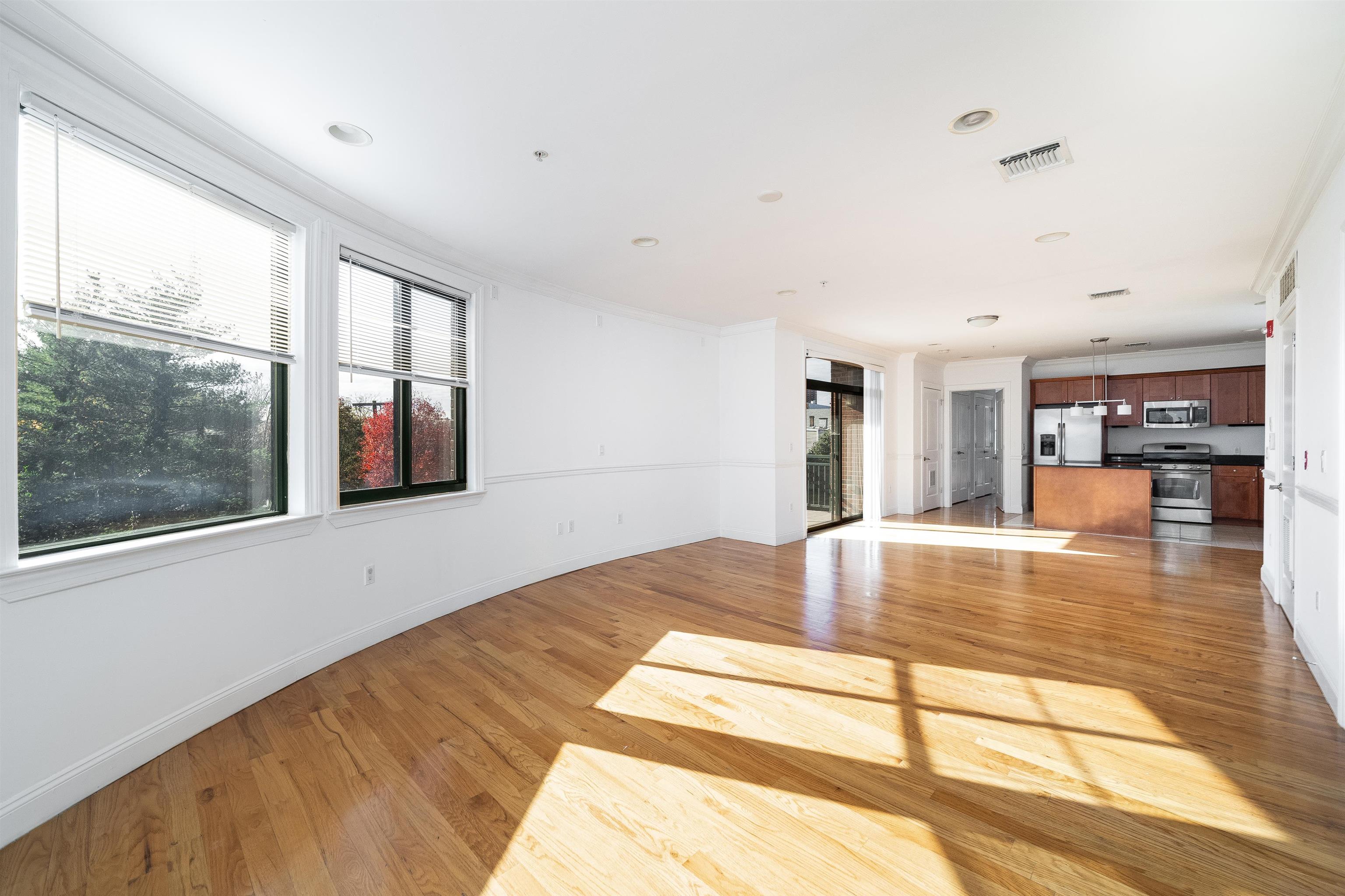 85 Maple Street, Unit 3K Weehawken, NJ 07086 - Photo 4 of 14 a swimming pool with large glass windows and painted walls