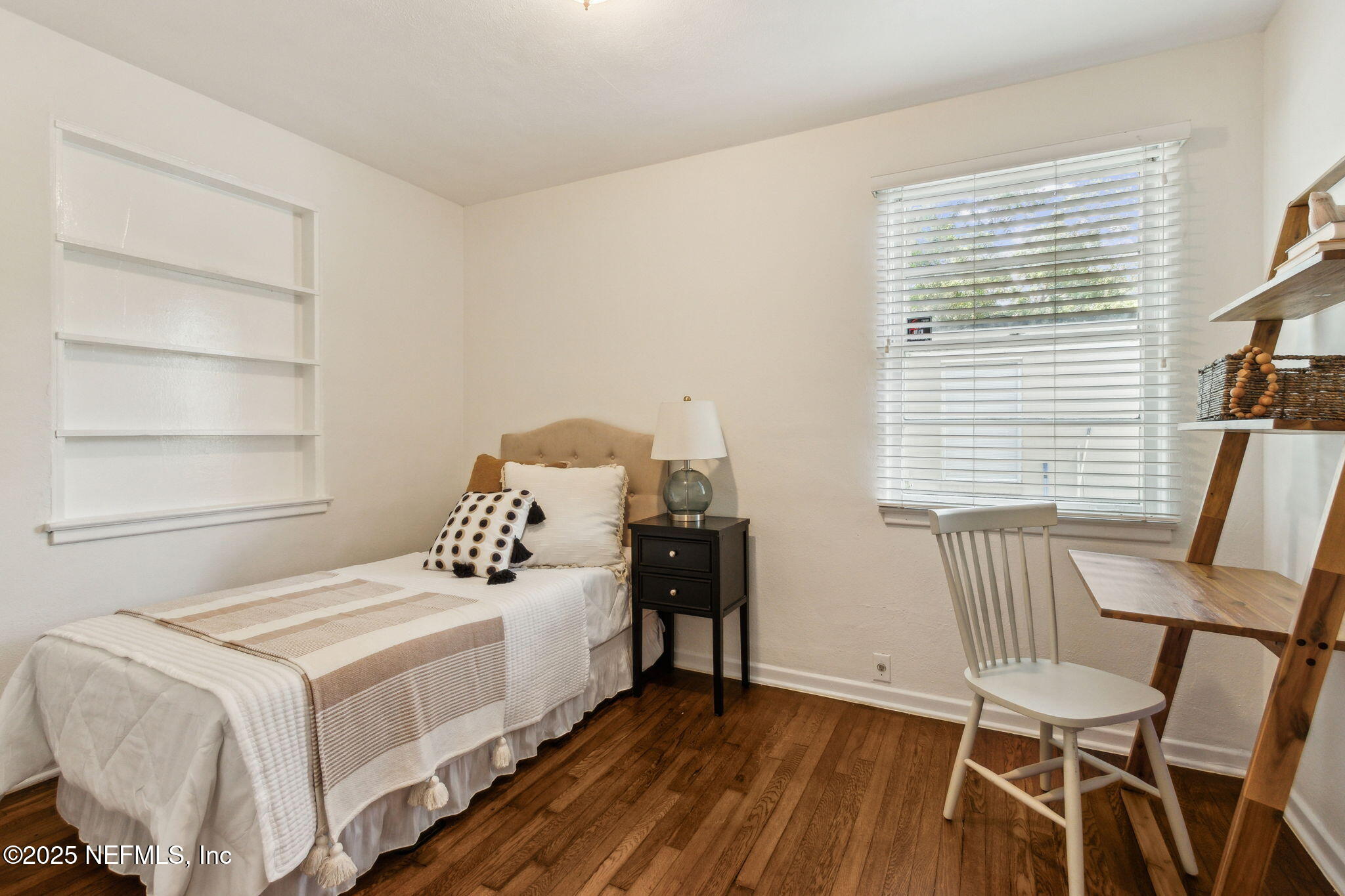 4646 Homestead Road Jacksonville, FL 32210 - Photo 17 of 34 a bedroom with a bed and a chair