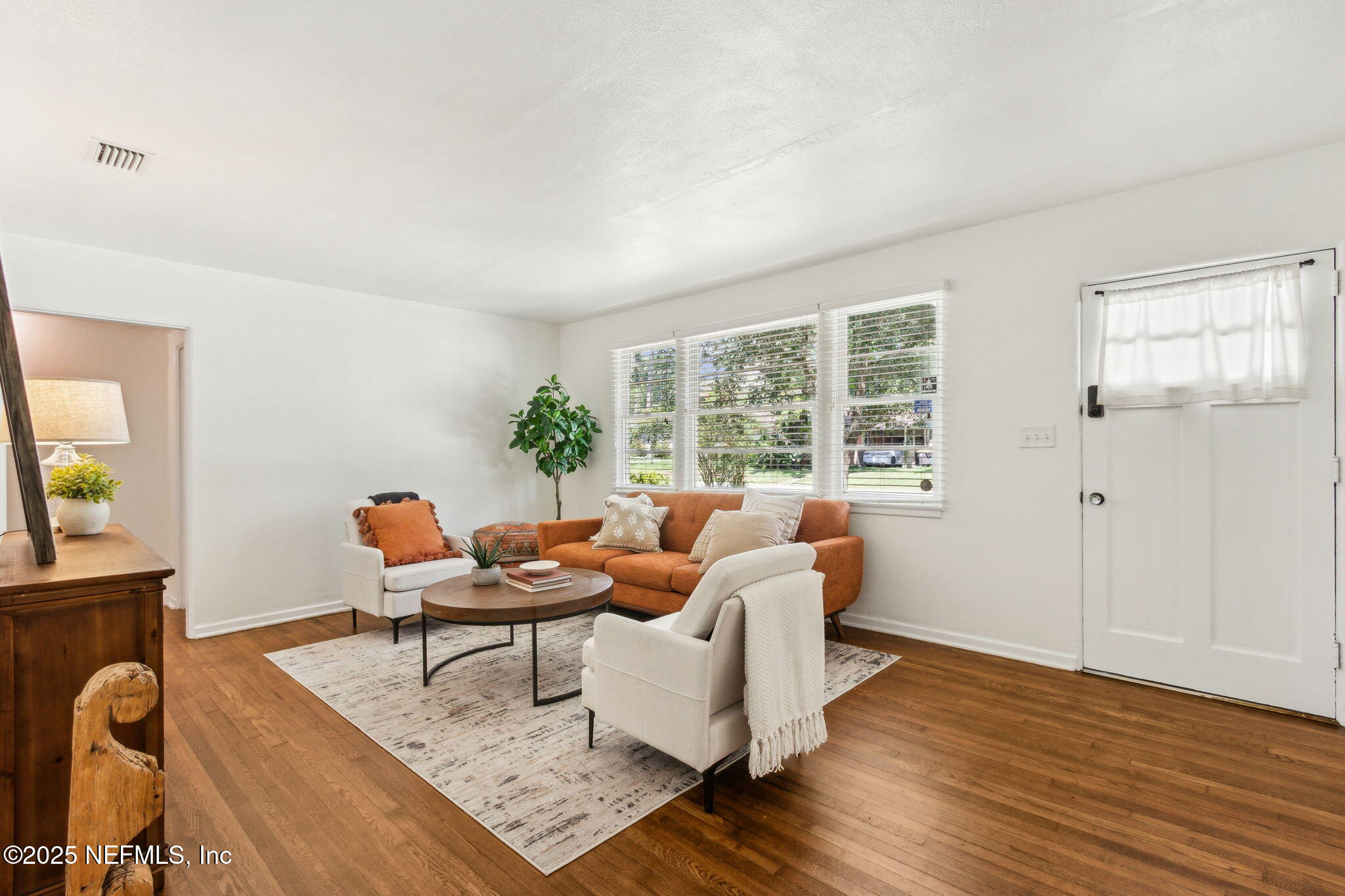 4646 Homestead Road Jacksonville, FL 32210 - Photo 3 of 34 a living room with furniture and wooden floor