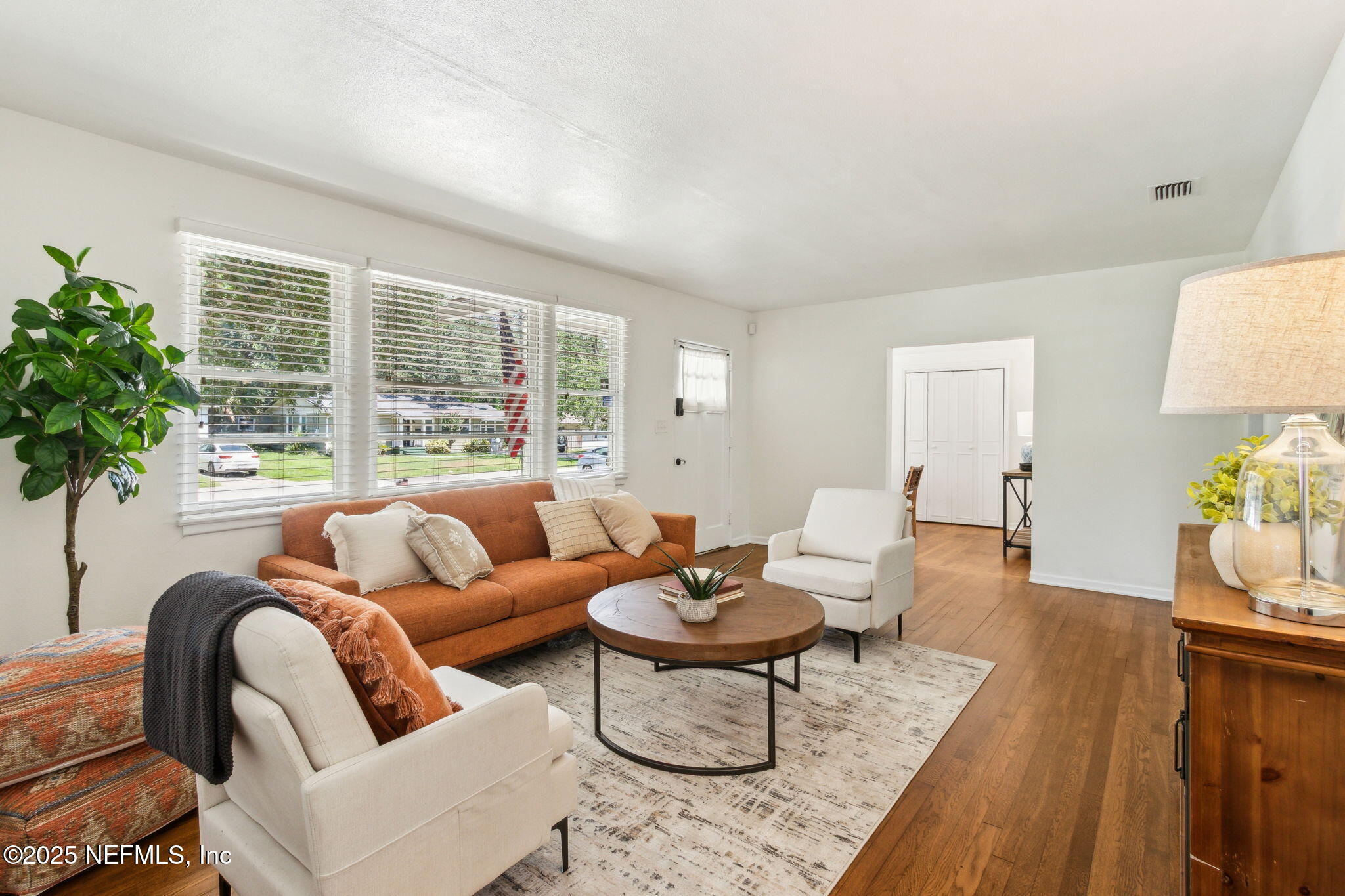 4646 Homestead Road Jacksonville, FL 32210 - Photo 4 of 34 a living room with furniture potted plant and a large window
