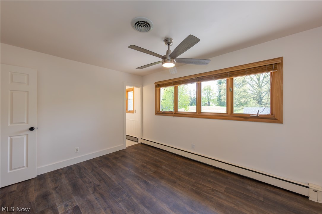 7969 Dines Road Novelty, OH 44072 - Photo 20 of 48 Primary bedroom wood-finish flooring, a contemporary ceiling fan with integrated lighting, and a multi-pane window with wood trim