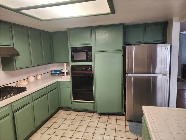 a kitchen with a refrigerator and a sink